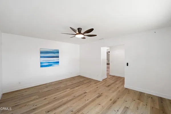 a view of a ceiling fan with wooden floor