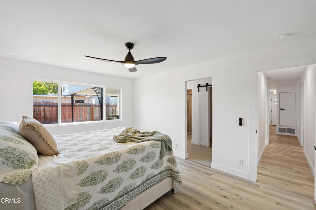 930 Topsail Court Oxnard, CA 93035 - Photo 25 of 31 a bedroom with a bed and wooden floor