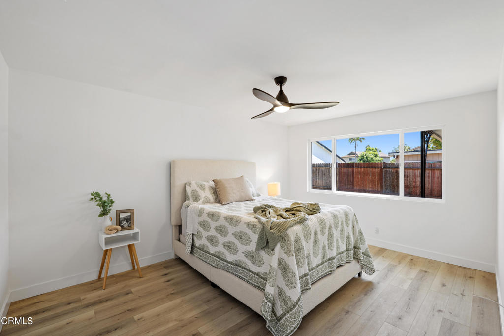 930 Topsail Court Oxnard, CA 93035 - Photo 26 of 31 a bedroom with a bed and wooden floor