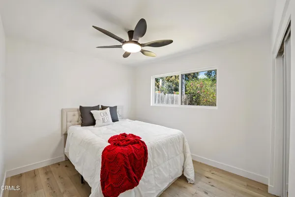 a bedroom with a bed and a window