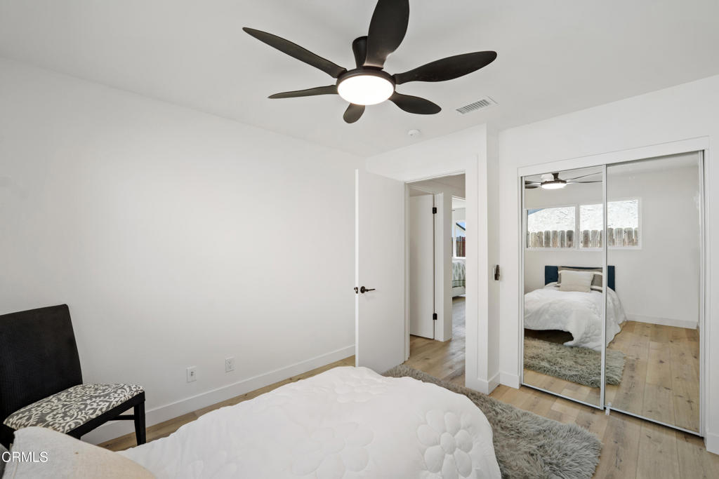 930 Topsail Court Oxnard, CA 93035 - Photo 28 of 31 a bedroom with a bed and a chandelier