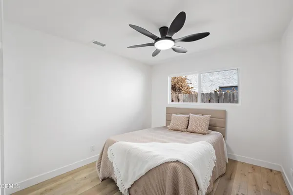 a bedroom with a large bed and a chandelier