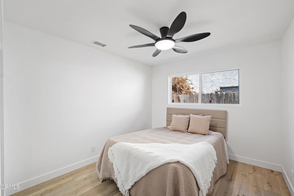 930 Topsail Court Oxnard, CA 93035 - Photo 29 of 31 a bedroom with a large bed and a chandelier