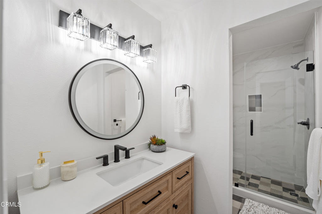 930 Topsail Court Oxnard, CA 93035 - Photo 30 of 31 a bathroom with a sink a mirror and a shower