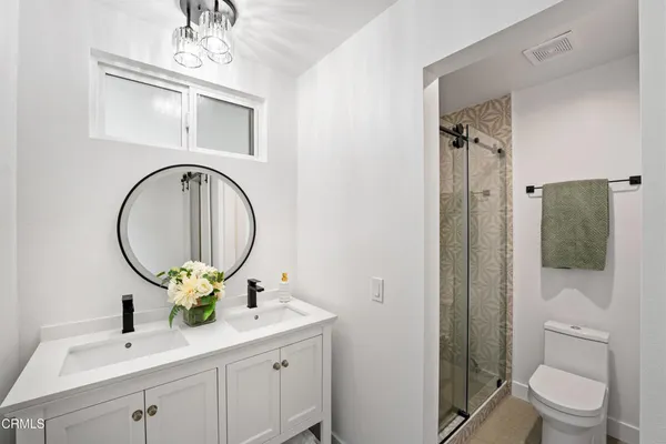 a bathroom with a toilet a sink and a mirror