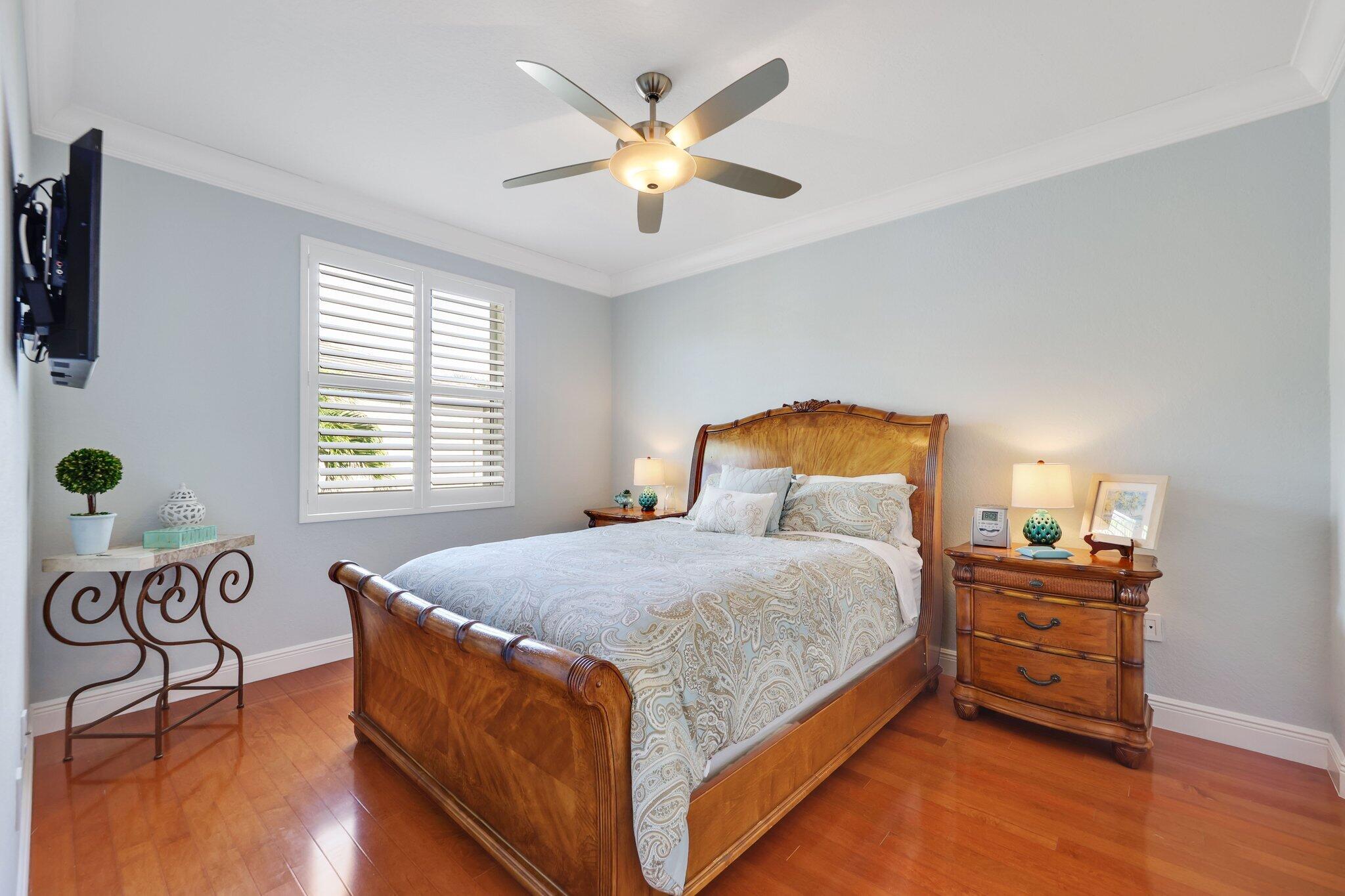 19245 Skyridge Circle Boca Raton, FL 33498 - Photo 44 of 70 a bedroom with a bed and a chandelier