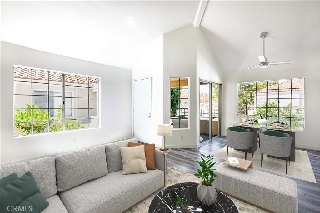 a living room with furniture and floor to ceiling windows
