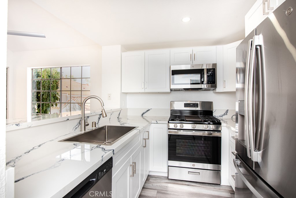 4240 Lost Hills Road, Unit 3108 Calabasas, CA 91301 - Photo 11 of 28 a kitchen with a sink stove and refrigerator
