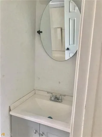 a white toilet sitting next to a bathroom sink
