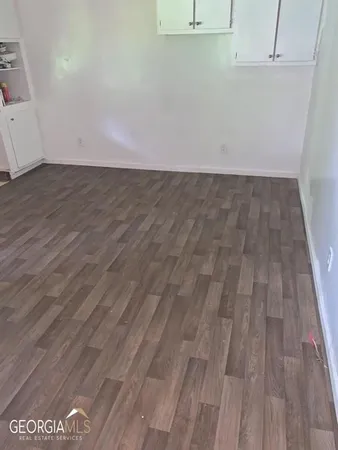 a view of a room with wooden floor