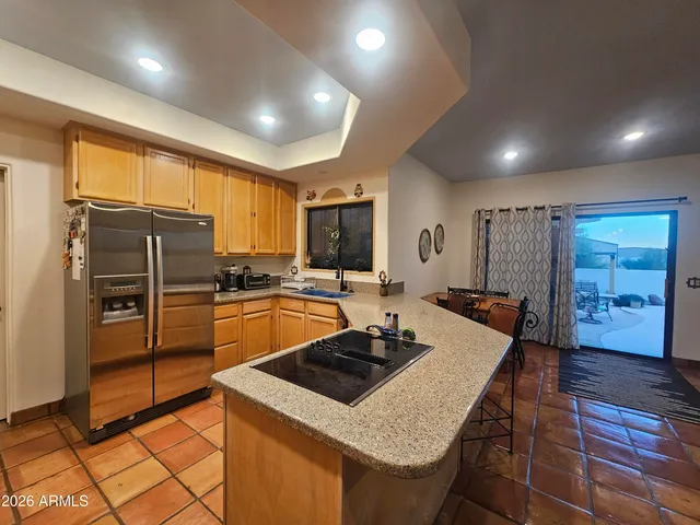 a kitchen with sink refrigerator and cabinets