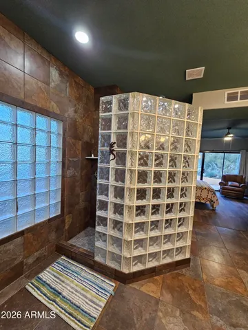 a view of an empty room with wooden floor and a cabinet