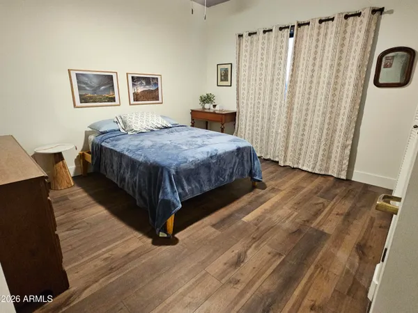 a spacious bedroom with a bed and a window