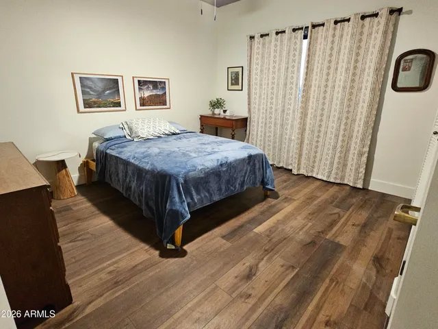 a spacious bedroom with a bed and a window