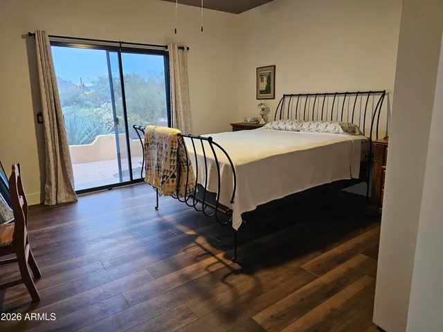 a bedroom with a bed and a large window