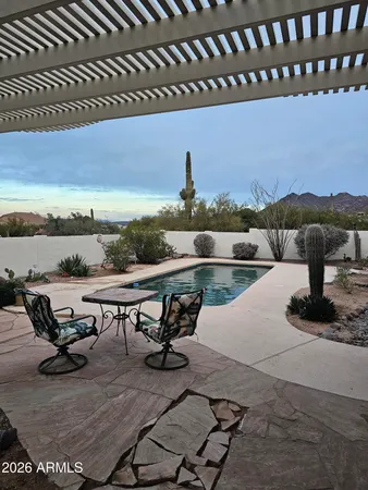 a view of a lake with outdoor seating