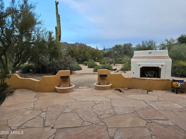 a view of roof deck with a table and chairs