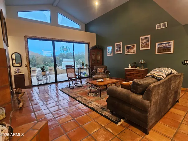 a living room with furniture and a floor to ceiling window