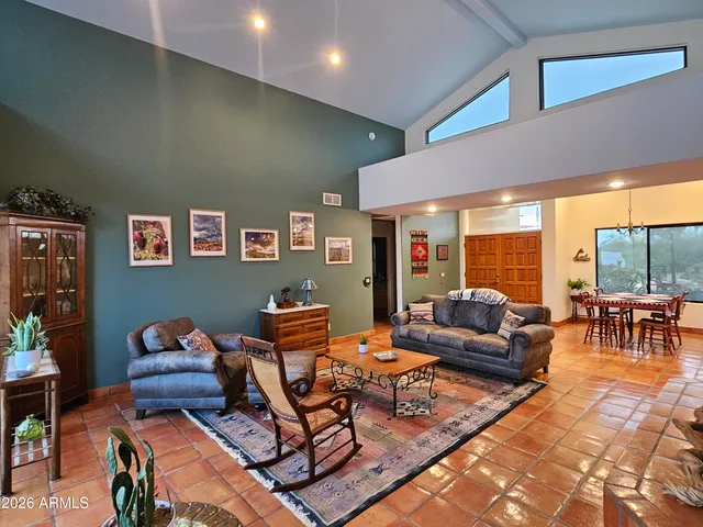 a living room with furniture a table and a large window
