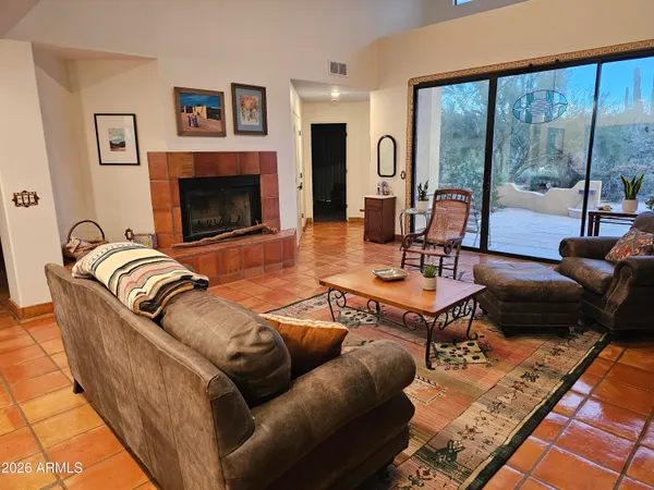 a living room with furniture large window and a fireplace