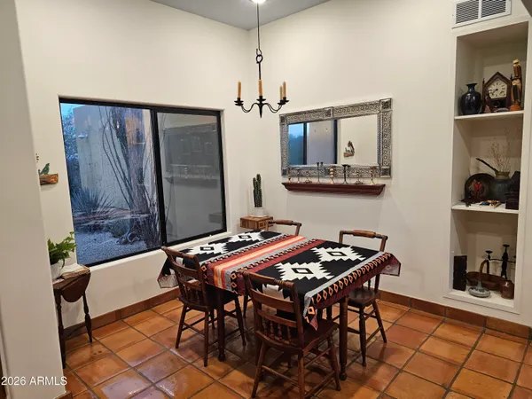 a view of a dining room with furniture and chandelier