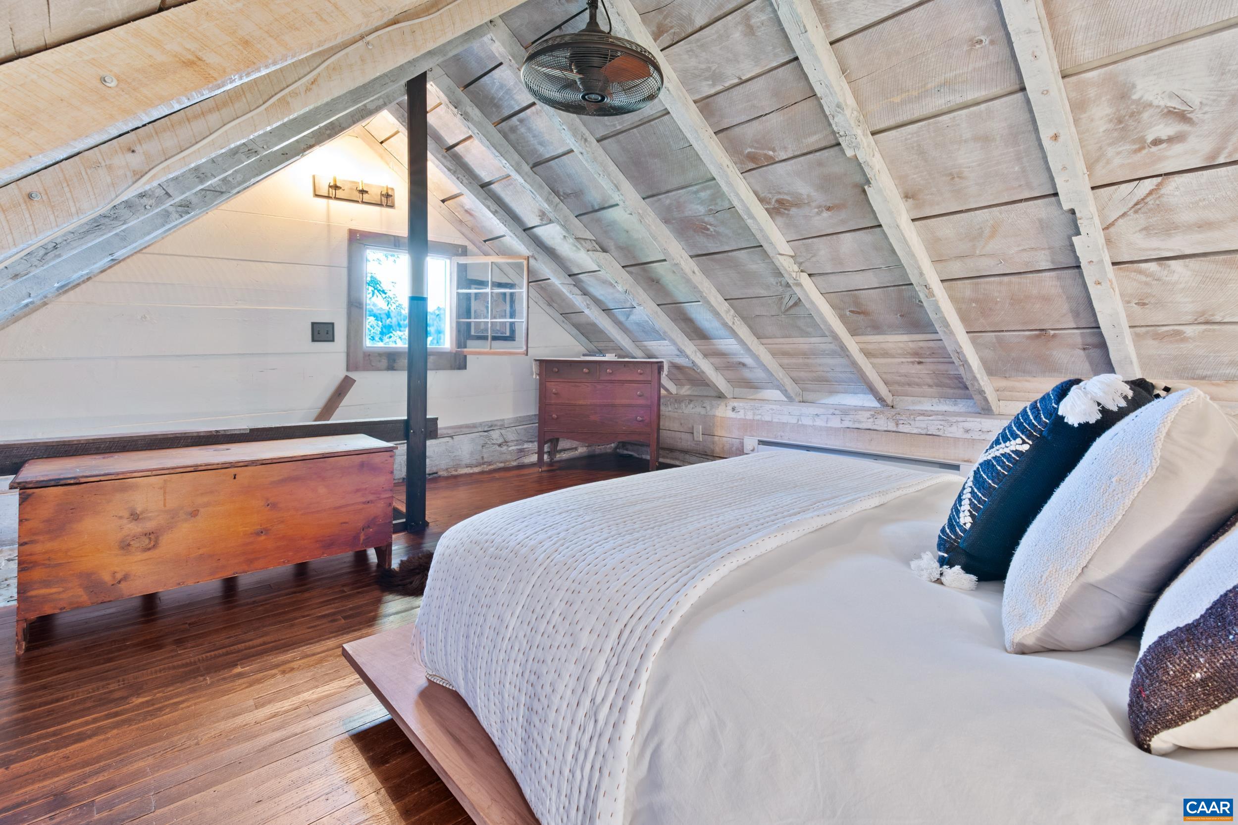 4925 Crabtree Falls Highway Tyro, VA 22976 - Photo 19 of 48 a bed sitting in a bedroom next to a window