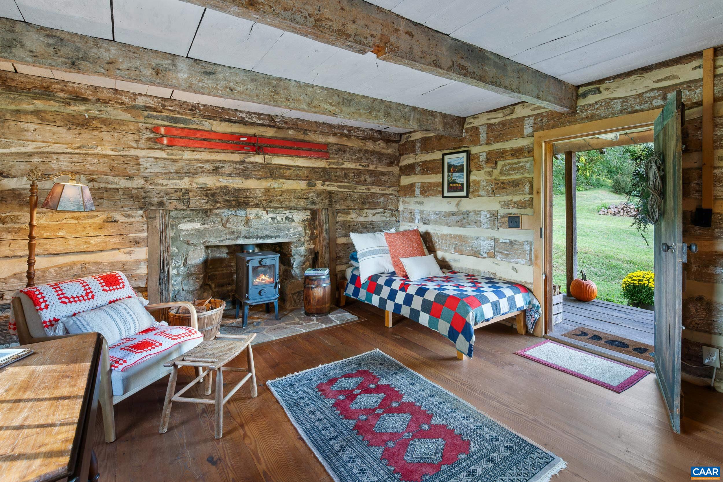 4925 Crabtree Falls Highway Tyro, VA 22976 - Photo 38 of 48 a bedroom with furniture and a fireplace