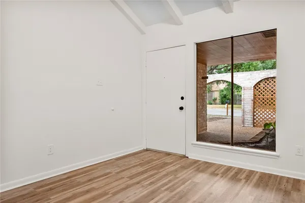 a view of a room with a glass door