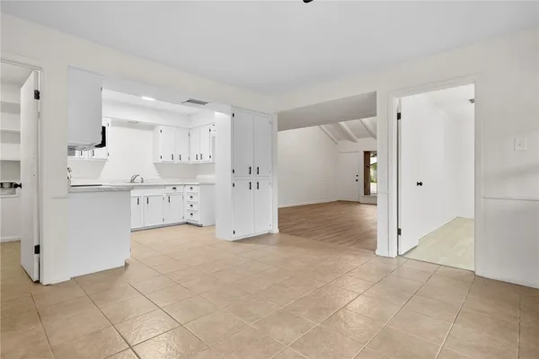 a view of kitchen with refrigerator and window