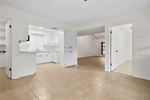 a view of kitchen with refrigerator and window