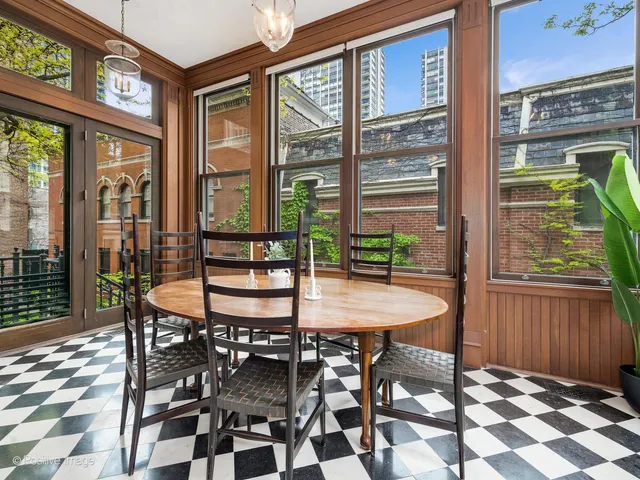 a living room with a fireplace and a potted plant