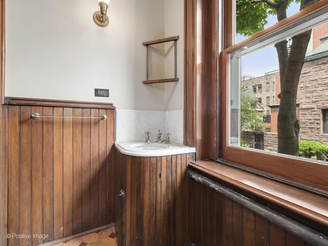 a bathroom with a bathtub a sink a mirror a window and a shower