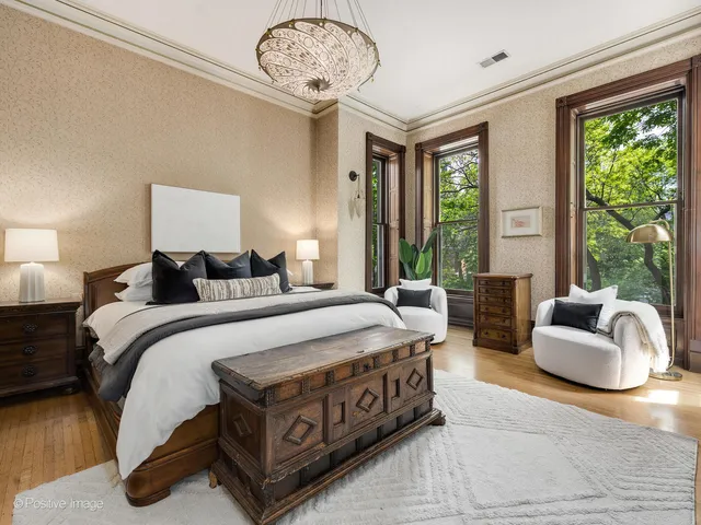 a living room with furniture kitchen view and a chandelier