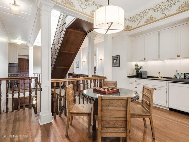 a view of a patio with couches and a table and chairs with wooden floor
