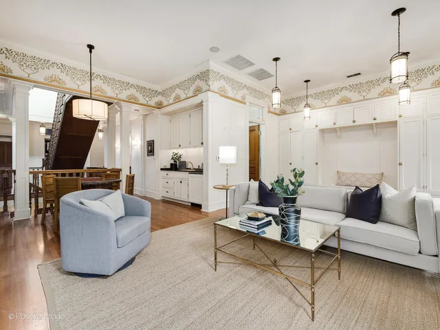 a living room with furniture and view of kitchen