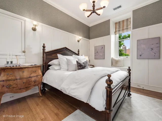a living room with furniture a chandelier and a fireplace