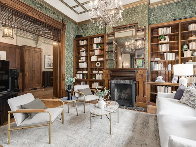 a living room with patio furniture and a chandelier