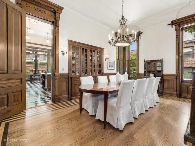 a view of a dining room with furniture large windows and wooden floor