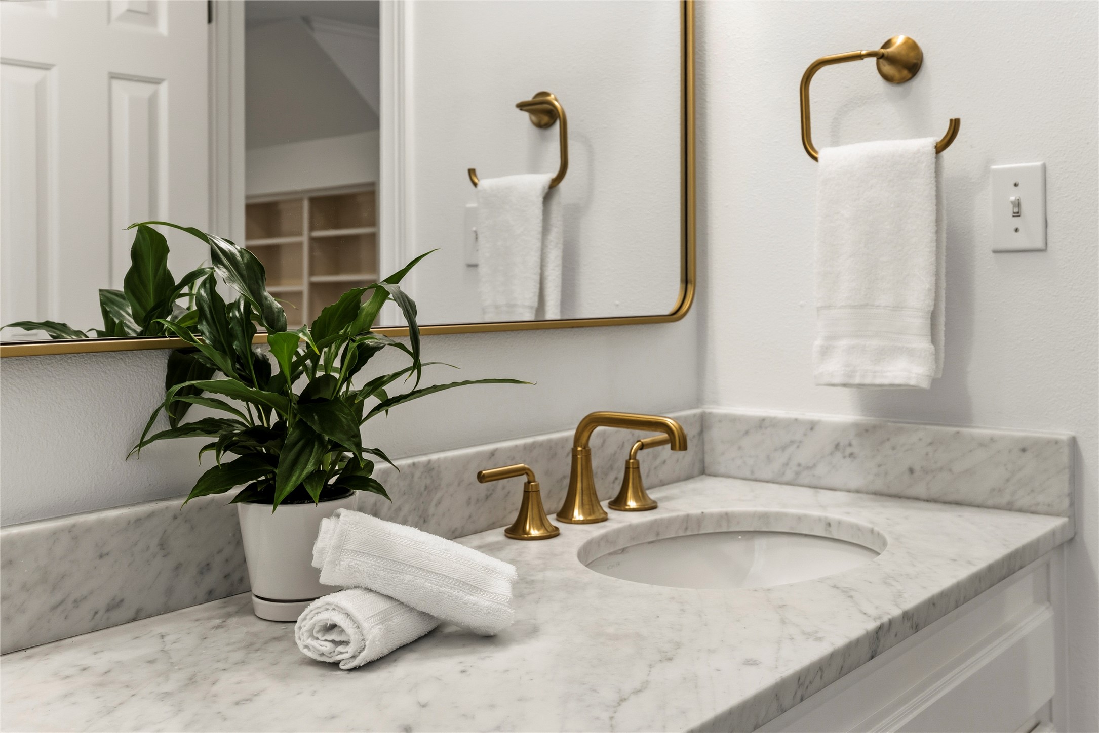 3107 Lookout Lane Austin, TX 78746 - Photo 34 of 39 Marble vanity with gold fixtures and crisp white walls.