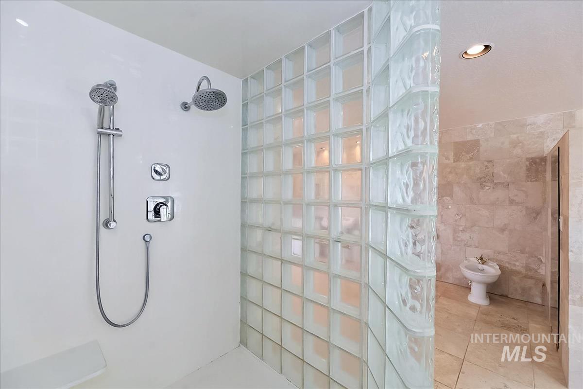 2804 West Sunrise Rim Road Boise, ID 83705 - Photo 43 of 50 Shower with dual showerheads, handheld sprayer, and built-in bench