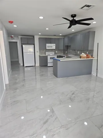 a view of kitchen with stainless steel appliances cabinets