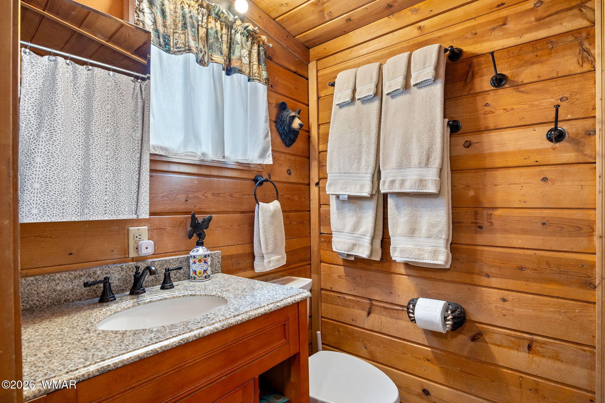 85 Main Street Greer, AZ 85927 - Photo 23 of 55 a bathroom with a granite countertop sink toilet and mirror