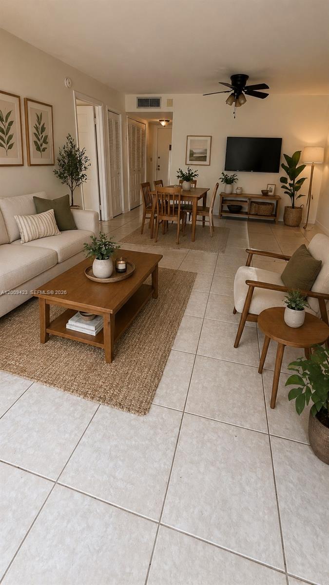 a living room with furniture and a flat screen tv