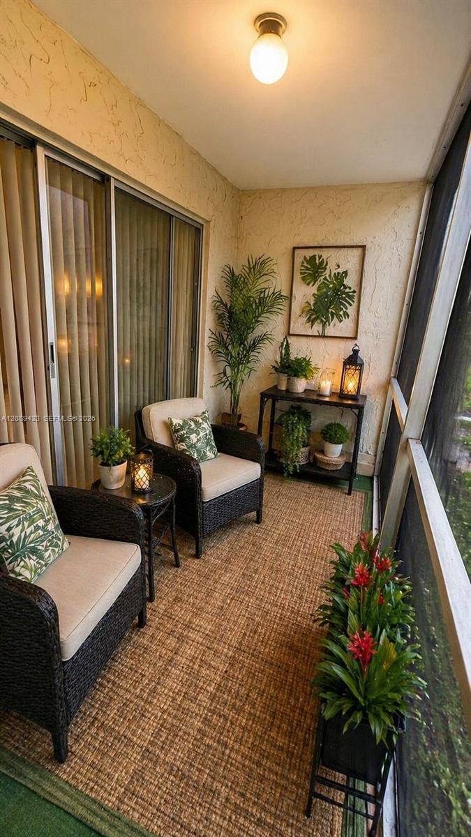 3774 Inverrary Boulevard, Unit 105P Lauderhill, FL 33319 - Photo 12 of 13 a living room with furniture and a potted plant