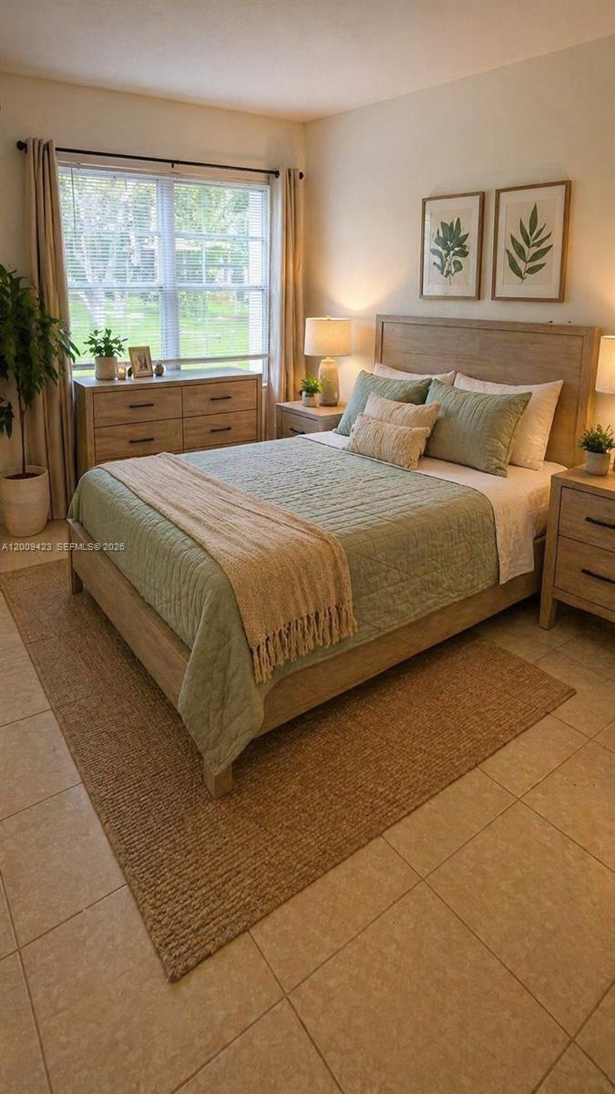 3774 Inverrary Boulevard, Unit 105P Lauderhill, FL 33319 - Photo 7 of 13 a bedroom with a large bed and a large window