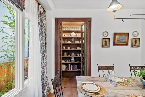 a spacious bedroom with a bed a mirror and a window