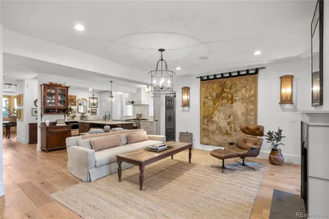 a kitchen with kitchen island a stove a sink a center island and wooden floor