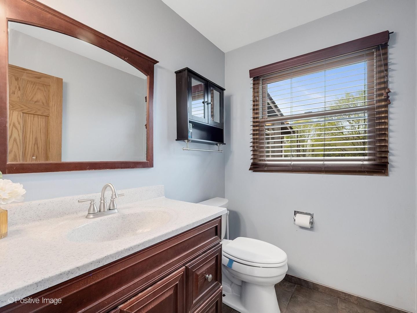 612 Stuart Drive Carol Stream, IL 60188 - Photo 16 of 29 a bathroom with a sink a toilet and mirror