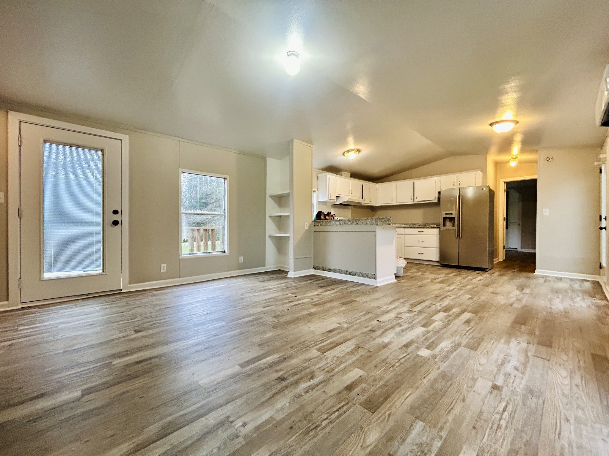 a view of a kitchen with a sink and a refrigerator