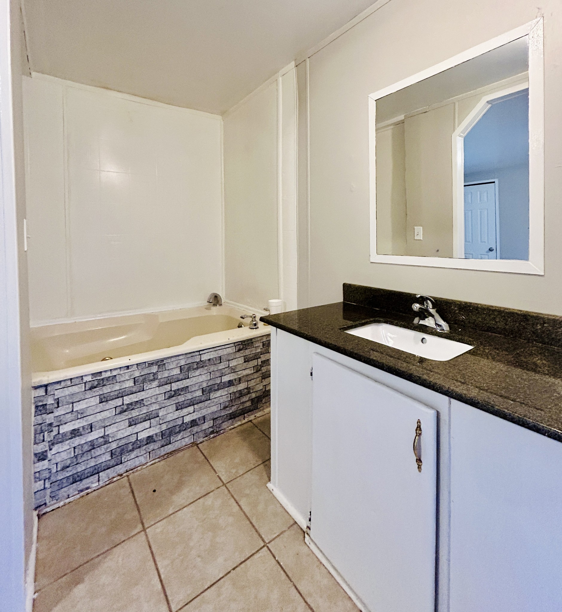789 Riddle Lane Estill Springs, TN 37330 - Photo 6 of 11 a bathroom with a granite countertop sink and a mirror